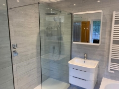 Rain shower with white bathroom unit and towel rail - Thomson Properties