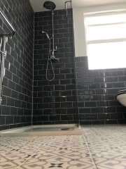 Bathroom refurbishment with patterned floor tiles, fitted by Thomson Properties