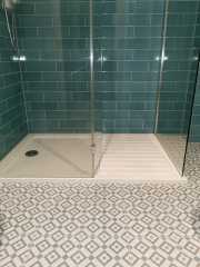 Patterned grey bathroom floor tiles with grey wall tiles, shower - Thomson Properties
