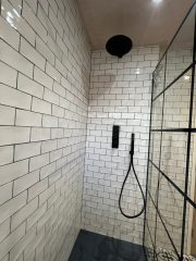 Black bathroom fittings in monochrome bathroom refurbishment by Thomson Properties