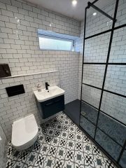 Monochrome bathroom refurbishment with patterned floor tiles, Thomson Properties