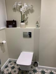 Cloakroom refurbishment with patterned floor tiles