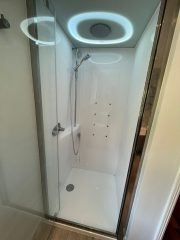 Complete bathroom refurbishment with integrated steam room shower pod by Thomson Properties