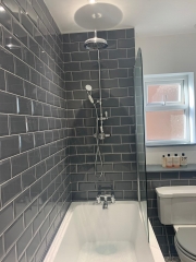 Metro tiled bathroom in grey, refurbished by Thomson Properties, Surrey and Sussex
