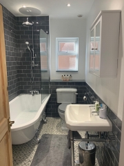 Grey bathroom refurbishment by Thomson Properties, Surrey and Sussex