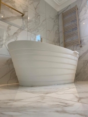 Freestanding bath, marble wall and floor tiles, bathroom refurbishment by Thomson Properties