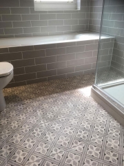 Patterned bathroom floor tiles as part of a full bathroom refurbishment by Thomson Properties