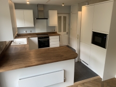 White kitchen installation with wooden worktops, Thomson Properties, Surrey and Sussex