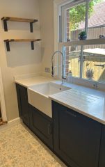 Kitchen refurbishment with patterned floor tiles and navy cupboards, Thomson Properties