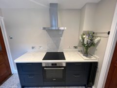 Stone worktops and dark blue kitchen cupboards, Thomson Properties
