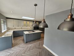 Pendant kitchen lighting, herringbone flooring, kitchen island - kitchen refurbishment by Thomson Properties, kitchen and bathroom specialists Surrey and Sussex