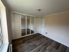 Bedroom flooring and cupboard fitting at Elmbridge Retirement Village Cranleigh by Thomson Properties