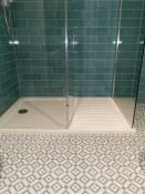 Patterned grey bathroom floor tiles with grey wall tiles, shower - Thomson Properties