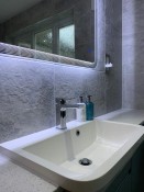 Illuminated bathroom mirror surround