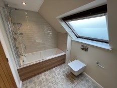 Bathroom installation with patterned floor tiles and brick wall tiles Surrey Thomson Properties