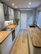 Kitchen refurbishment with wooden worktops and flooring by Thomson Properties