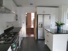 White kitchen with silver appliances fitted by Thomson Properties