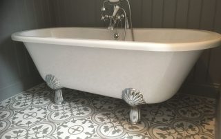 Claw footed freestanding bath and patterned floor tiles - Thomson Properties bathroom fitter Surrey and Sussex