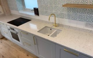 Patterned kitchen wall tiles and gold accents, Thomson Properties kitchen and bathroom fitters Surrey and Sussex