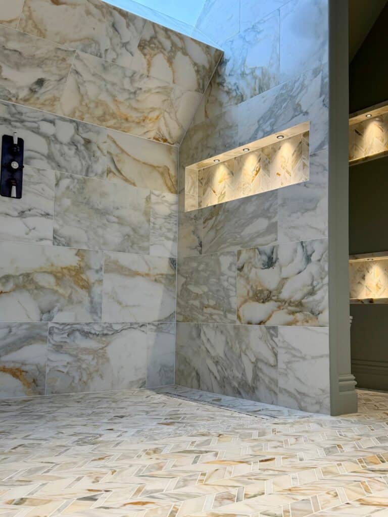 Illuminated recessed shelf set into the steam room marble wall.