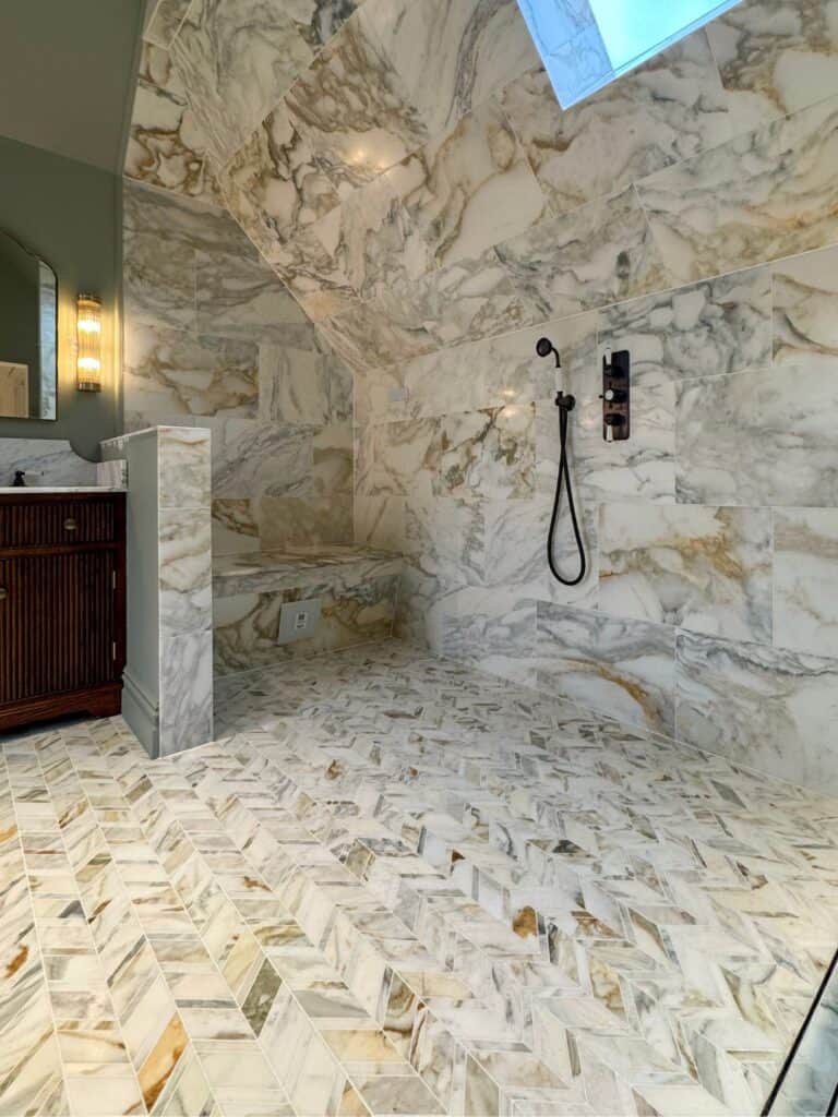 Marble steam room bench beside a handheld shower.